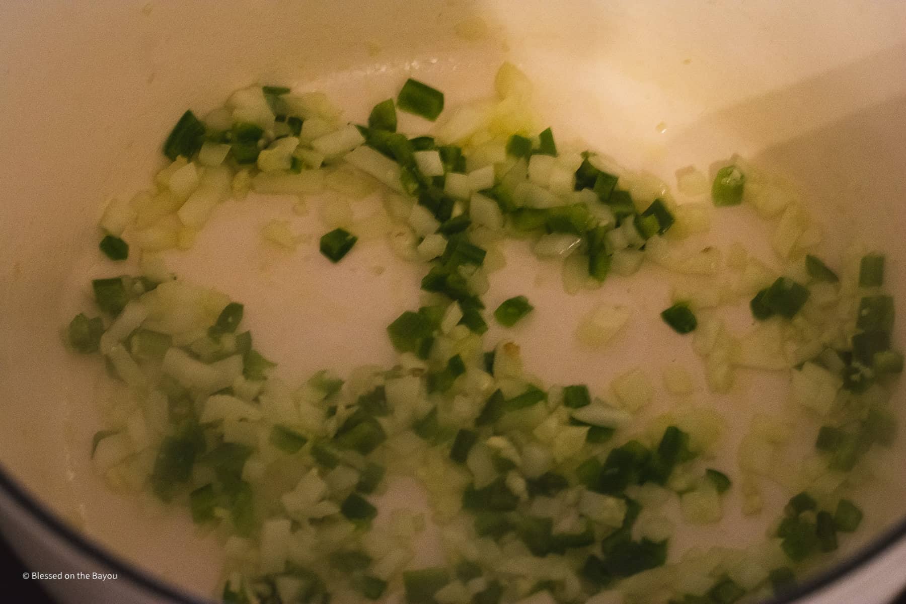 White onion, green bell pepper and garlic saute