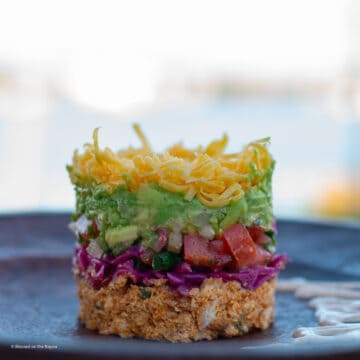 Baja Fish Taco Dip plated on a wood plate bayou in the background