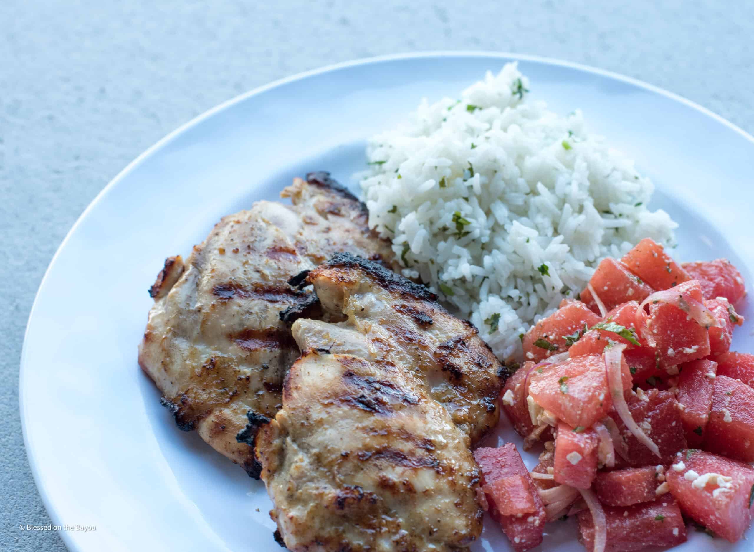 grilled mojo chicken plated with watermelon feta salad and cilantro lime rice