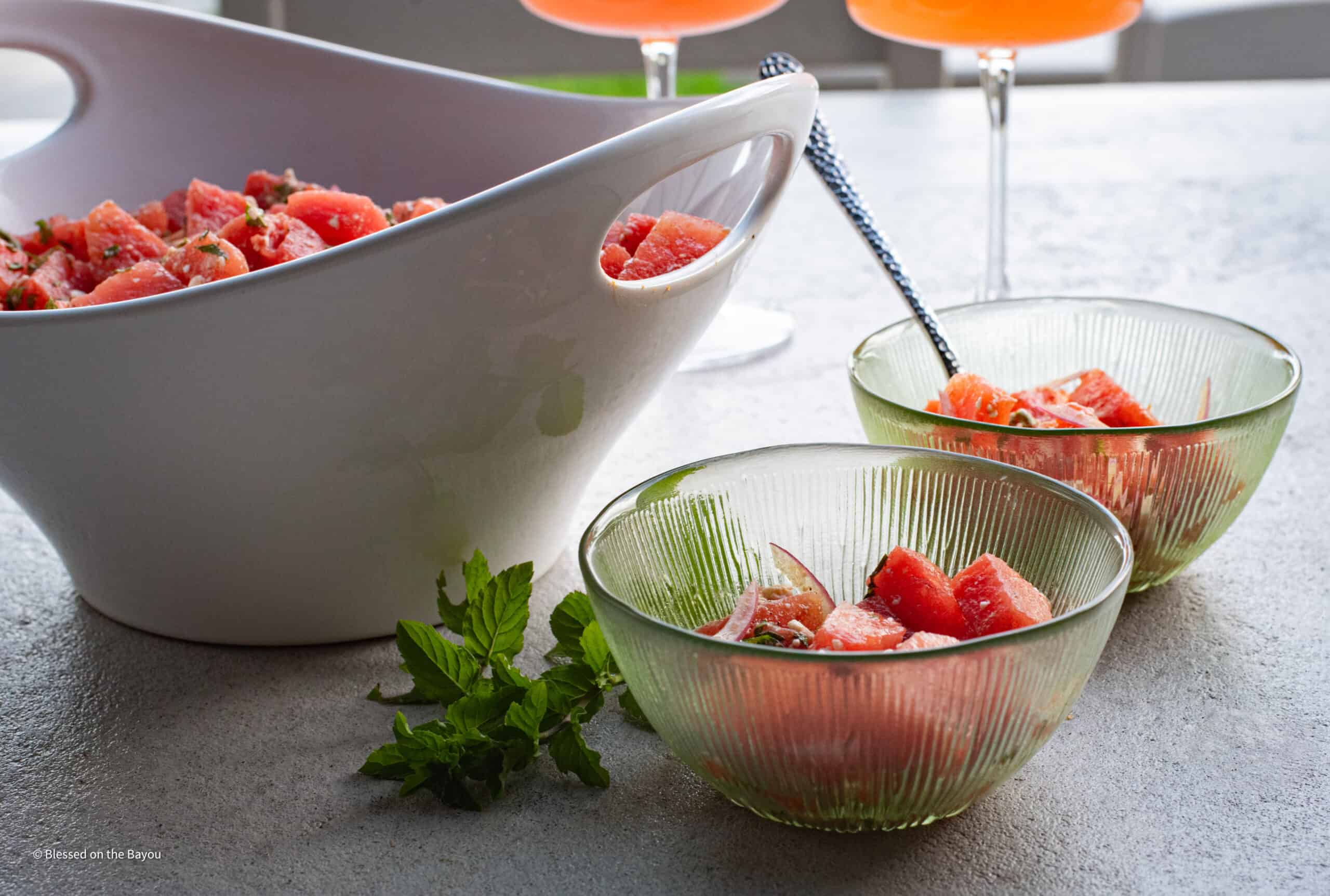 watermelon salad with two small bowls and mint