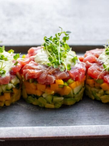 Tuna tartare stack plated with purple mustard sprouts