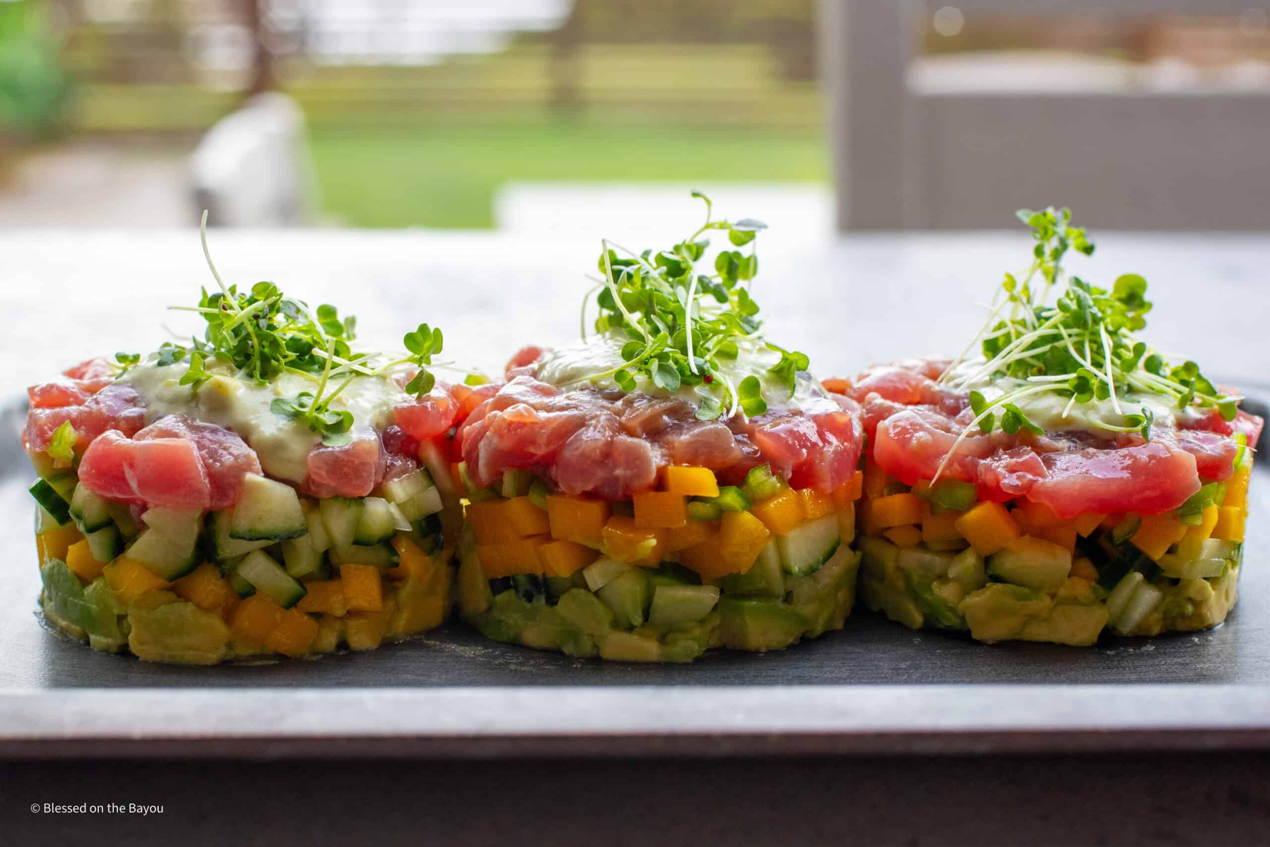 Tuna tartare stack plated with purple mustard sprouts