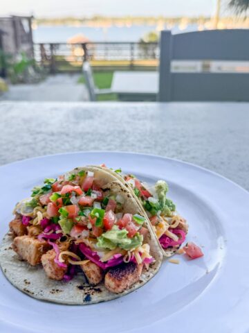 Cajun white fish tacos topped with avocado, pico de gallo, pickled red cabbage, and lime-jalapeño sauce